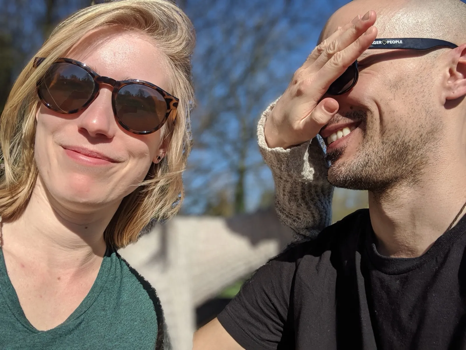 Anne playfully covering David's eyes during a sunny selfie.