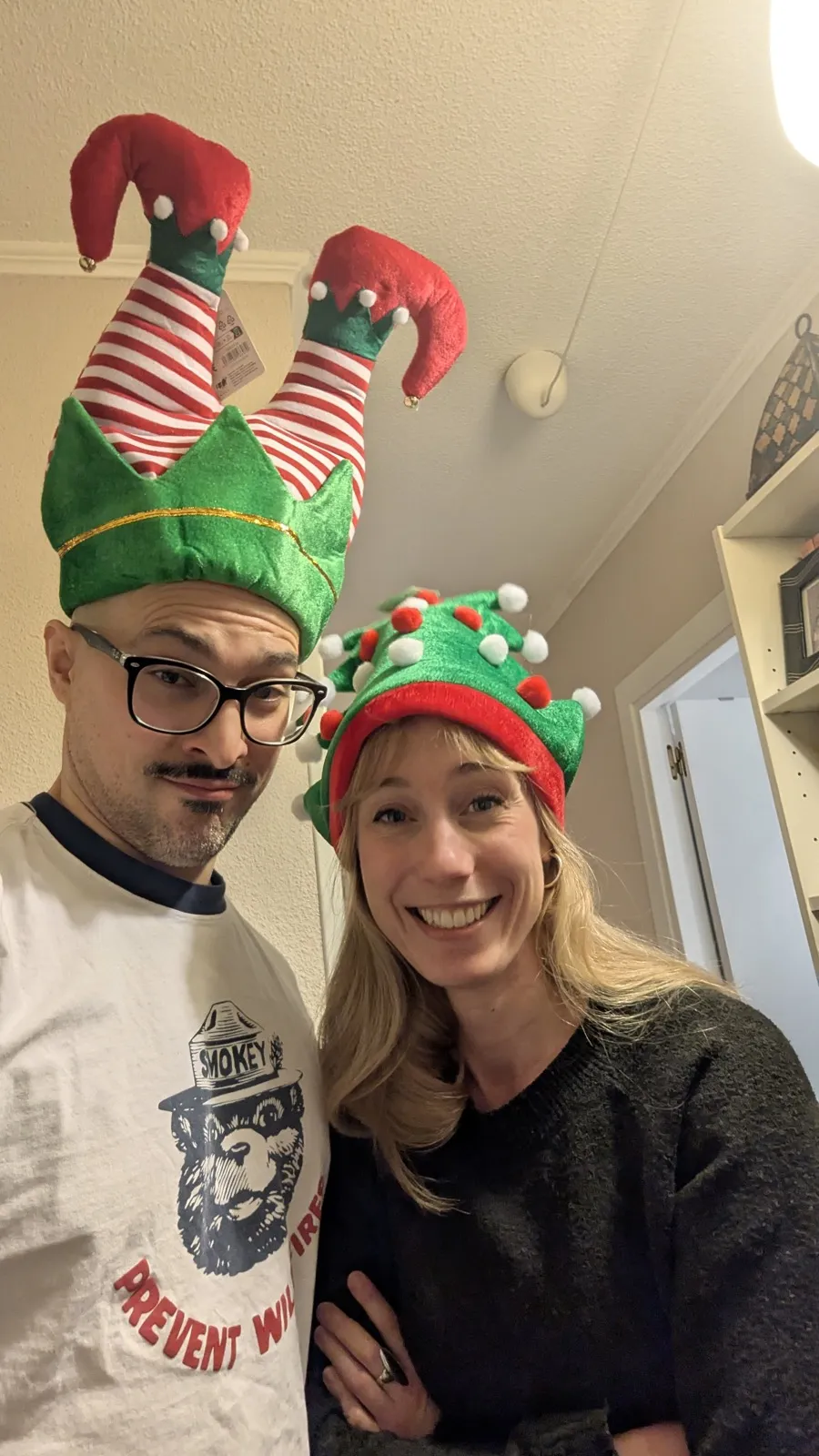 Anne and David wearing elf hats and big Christmas smiles.