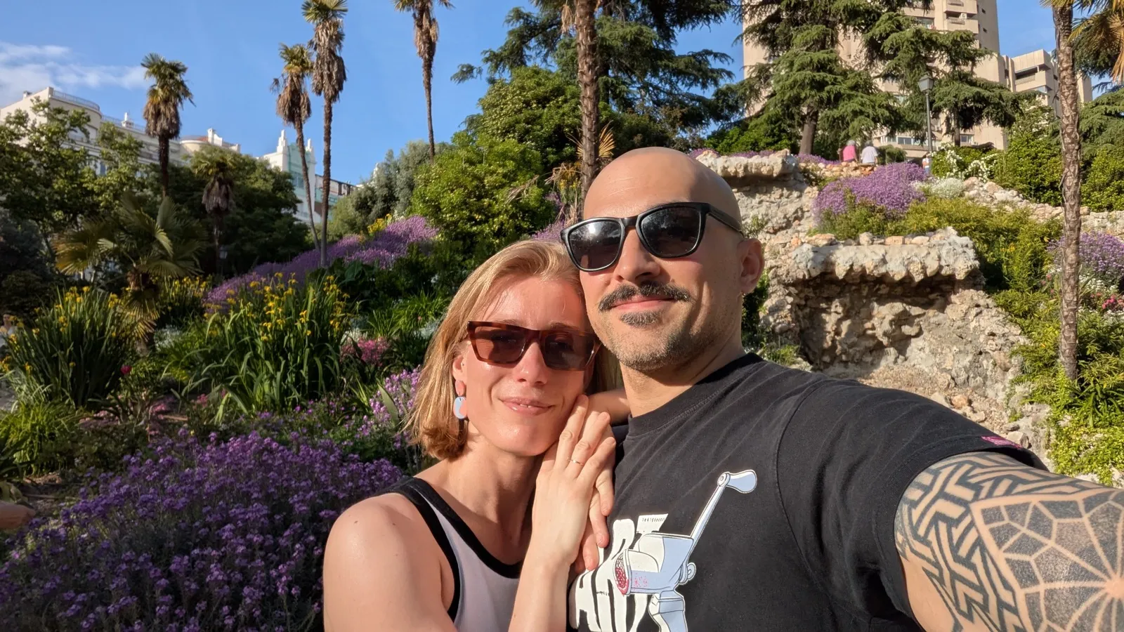 Anne and David together in a blooming botanical garden.